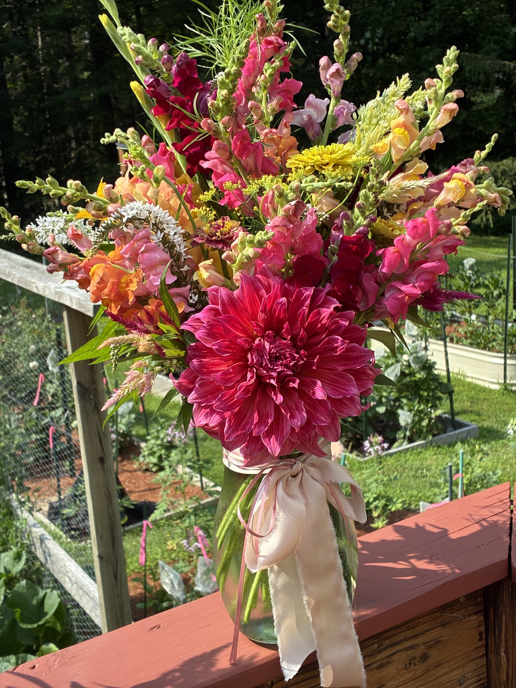 Bright bouquet with a burgundy dahlia and colorful snapdragons.