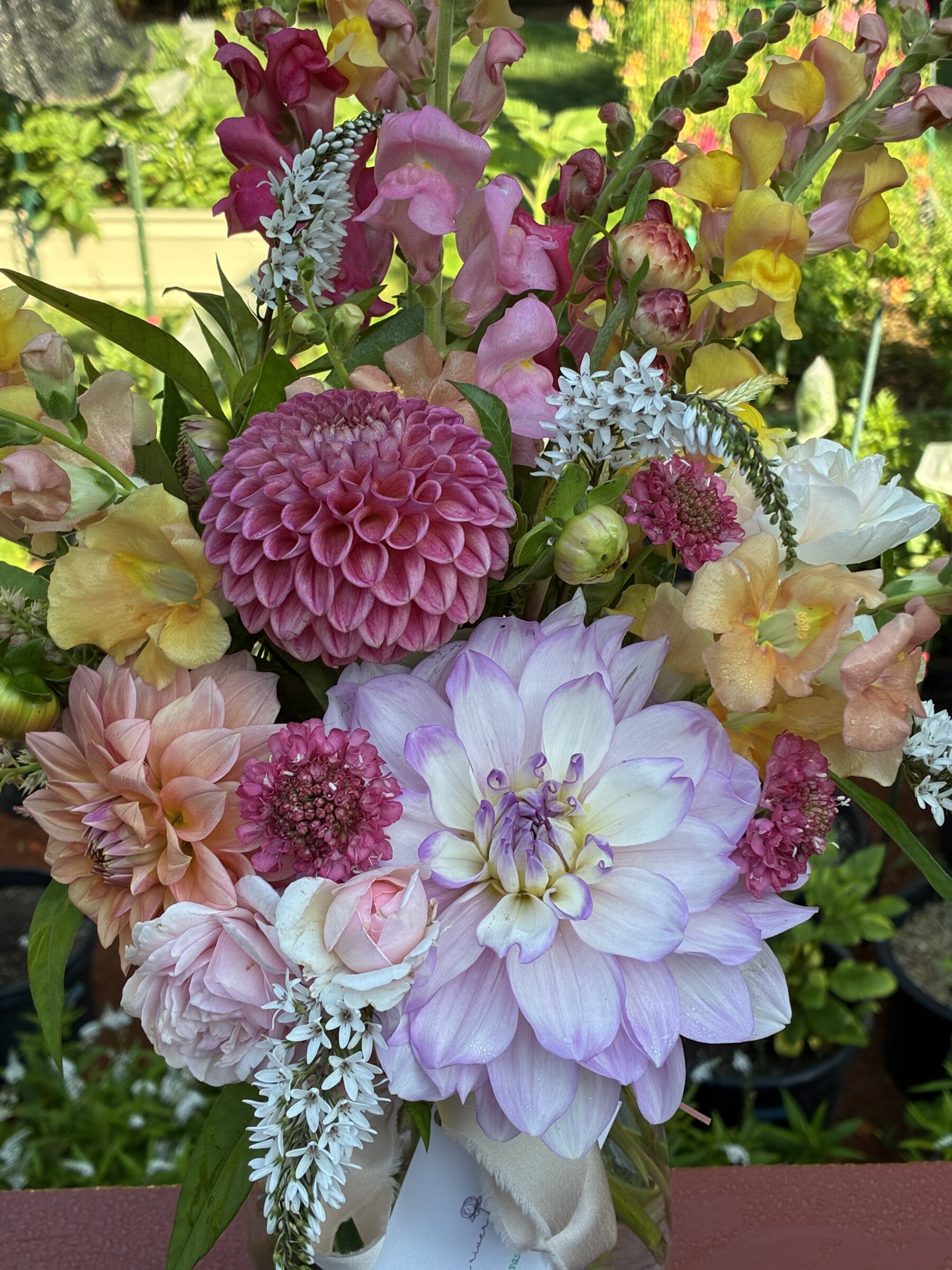 Pastel dahlias and snapdragons arranged in a seasonal bouquet.